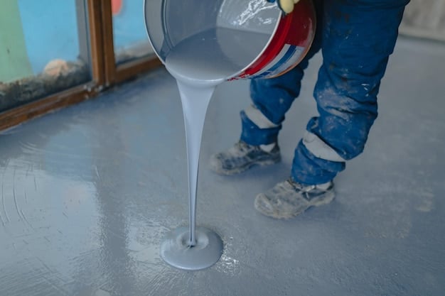 worker applies gray epoxy resin new floor 558893 410